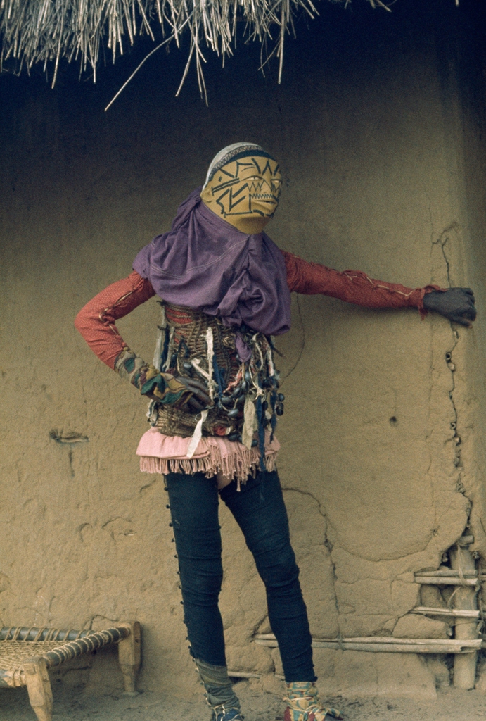 Personifying evil, a costumed mapico dancer in Mozambique hides from spectators, 1964.Photograph by Volkmar K. Wentzel